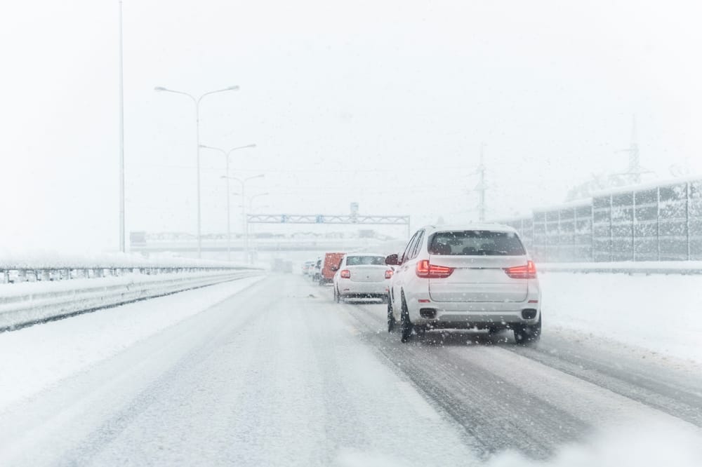 Vehicles driving during the winter months with snow on the ground