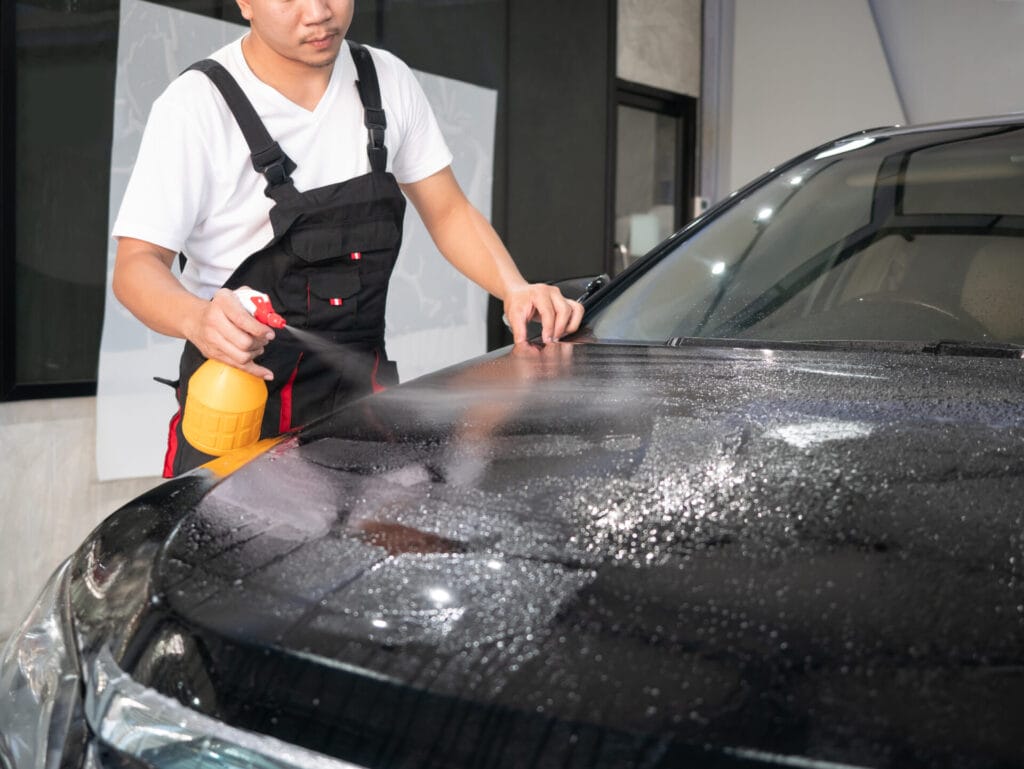 cleaning car hood. Preparing auto for car wrapping.